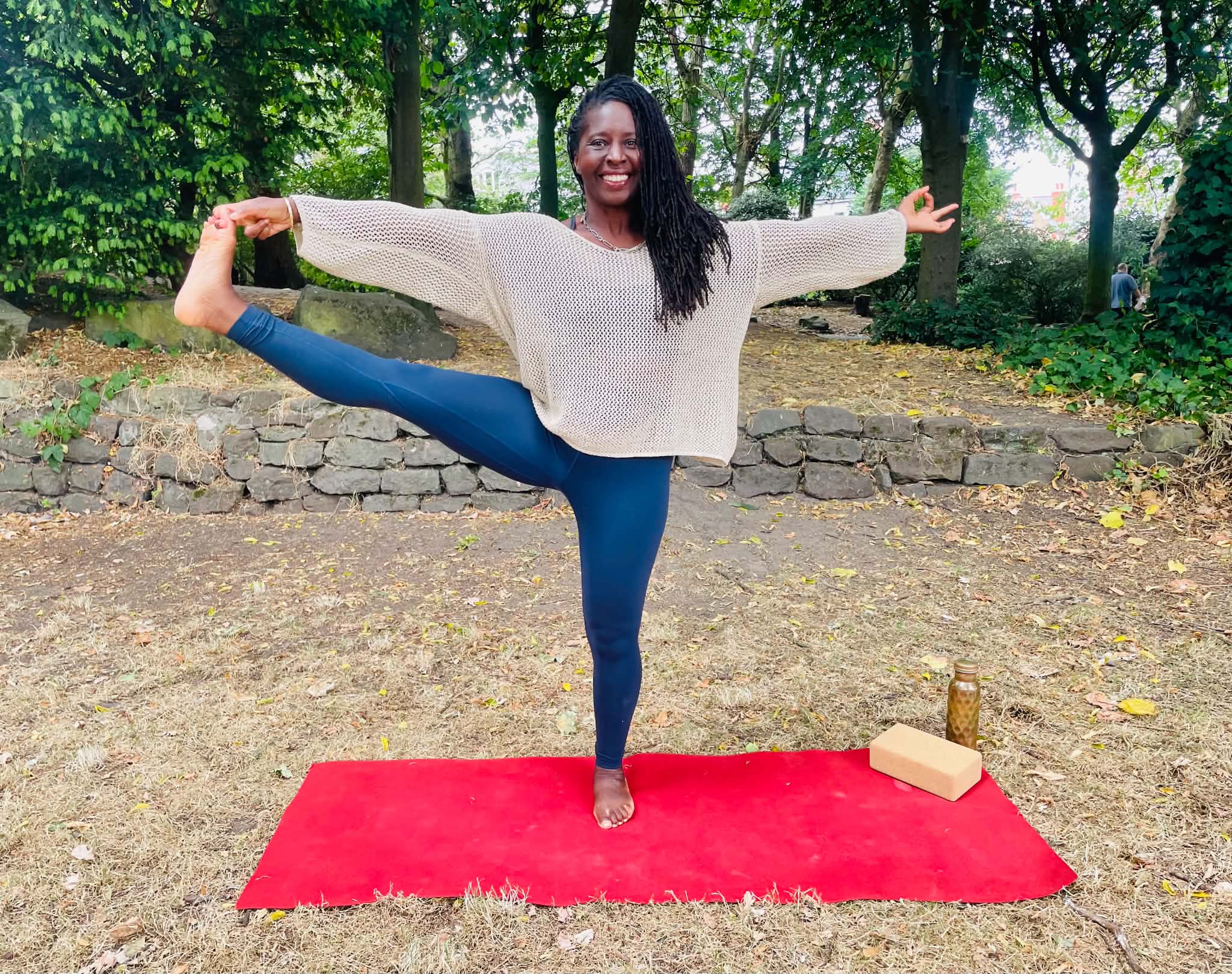Dionne practising a balancing yoga pose outdoors