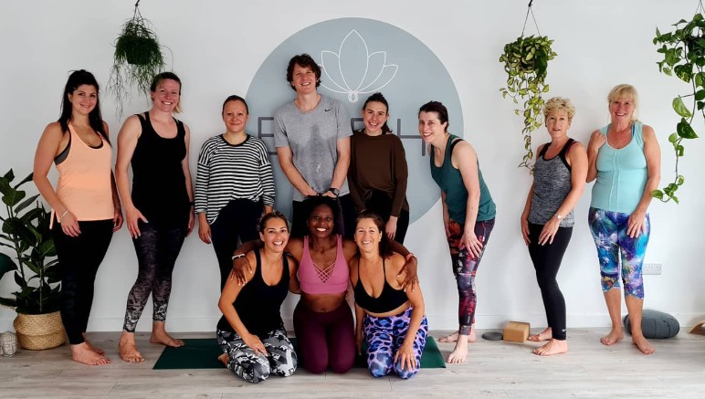 Dionne with a yoga group in the studio